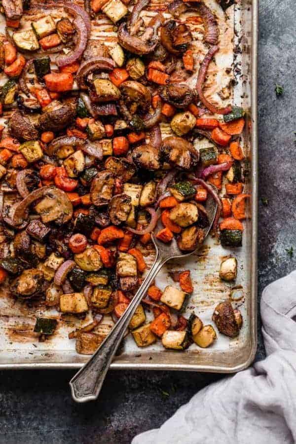 An overhead shot of the roasted vegetables on a sheet pan for the Balsamic Roasted Vegetable with Quinoa Salad