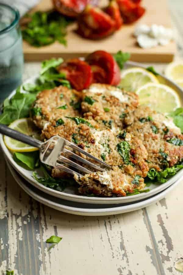 A fork pulling apart a Quinoa Spinach Turkey Burger with Goat Cheese 