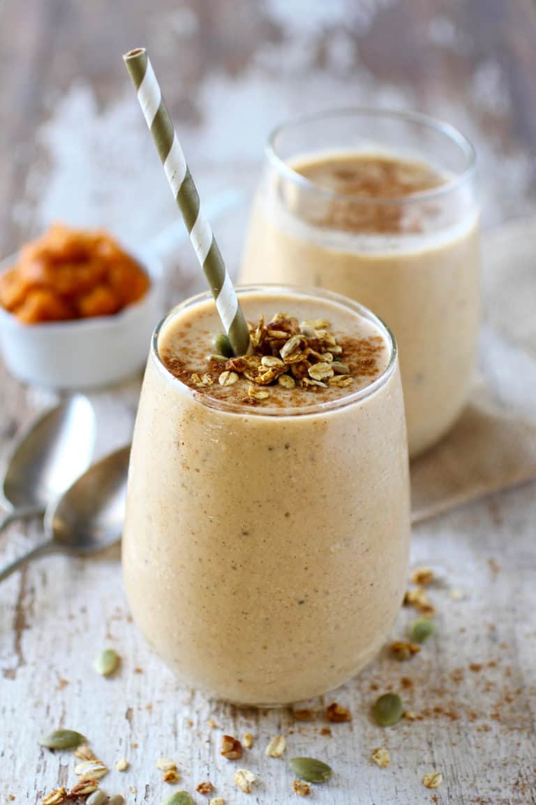 Pumpkin Pie Protein Smoothies topped with pumpkin pie spices in glasses. 