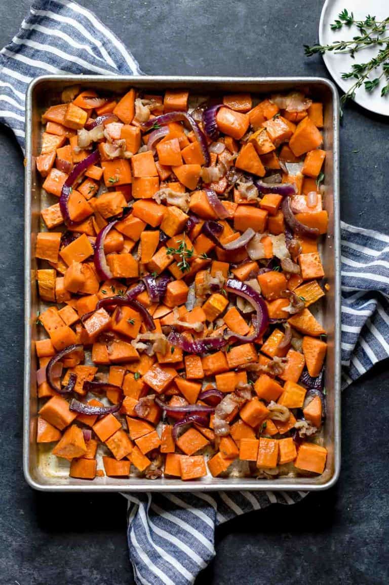 Overhead view sheet pan filled with maple bacon roasted sweet potatoes