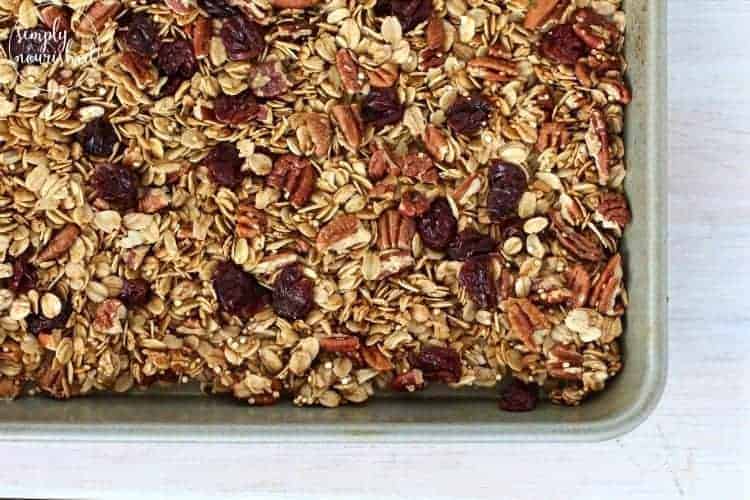 Cherry pecan granola with quinoa on a baking sheet.