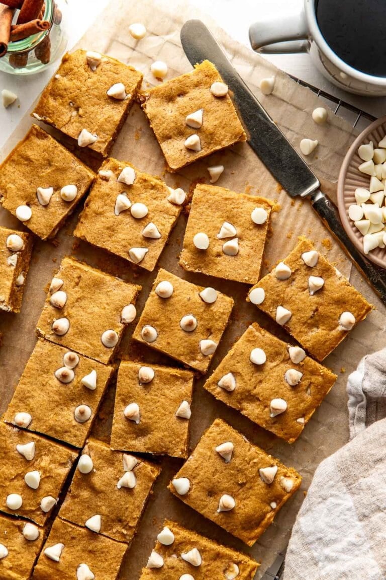 Pumpkin blondies topped with white chocolate chips.