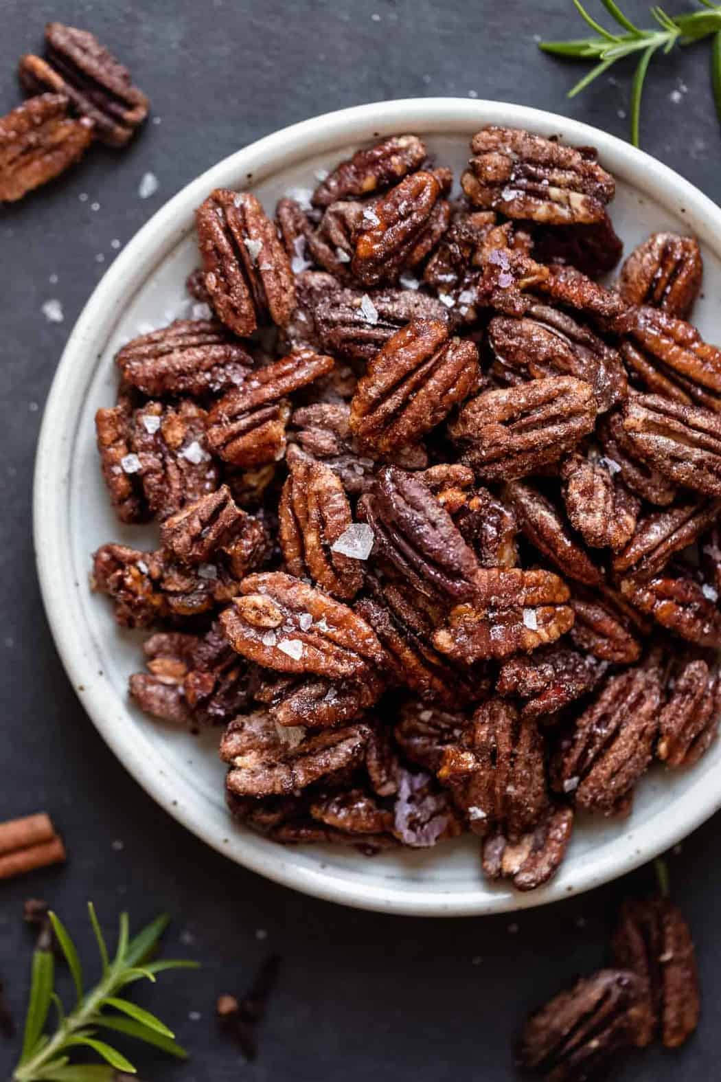 Overhead view of Holiday Spiced Pecans on a white plate.