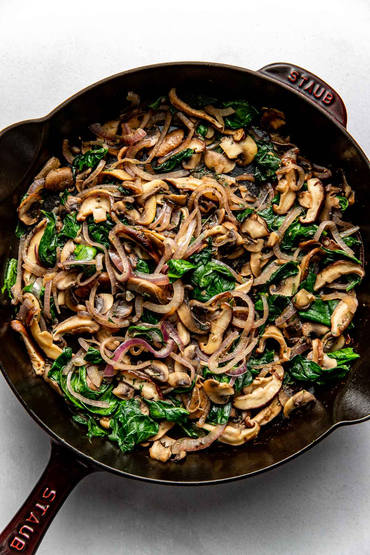 Overhead view of a pan filled with Mushroom Frittata ingredients ready for baking.