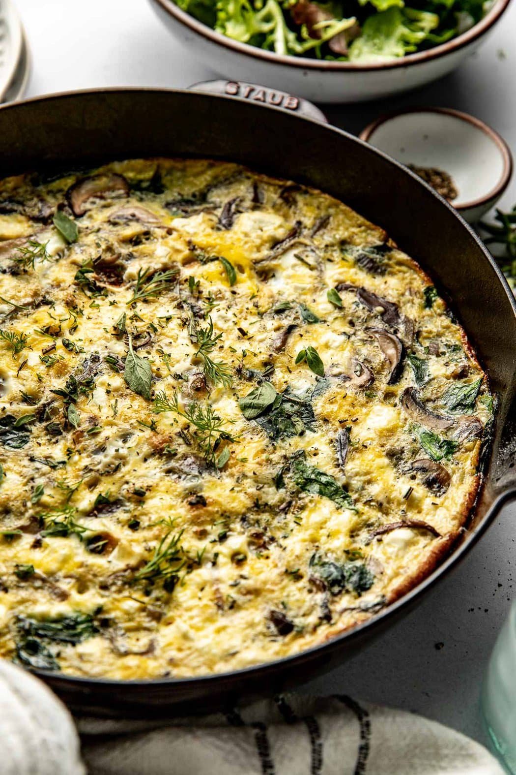 Overhead view of a pan of freshly baked Mushroom Frittata with Feta. 