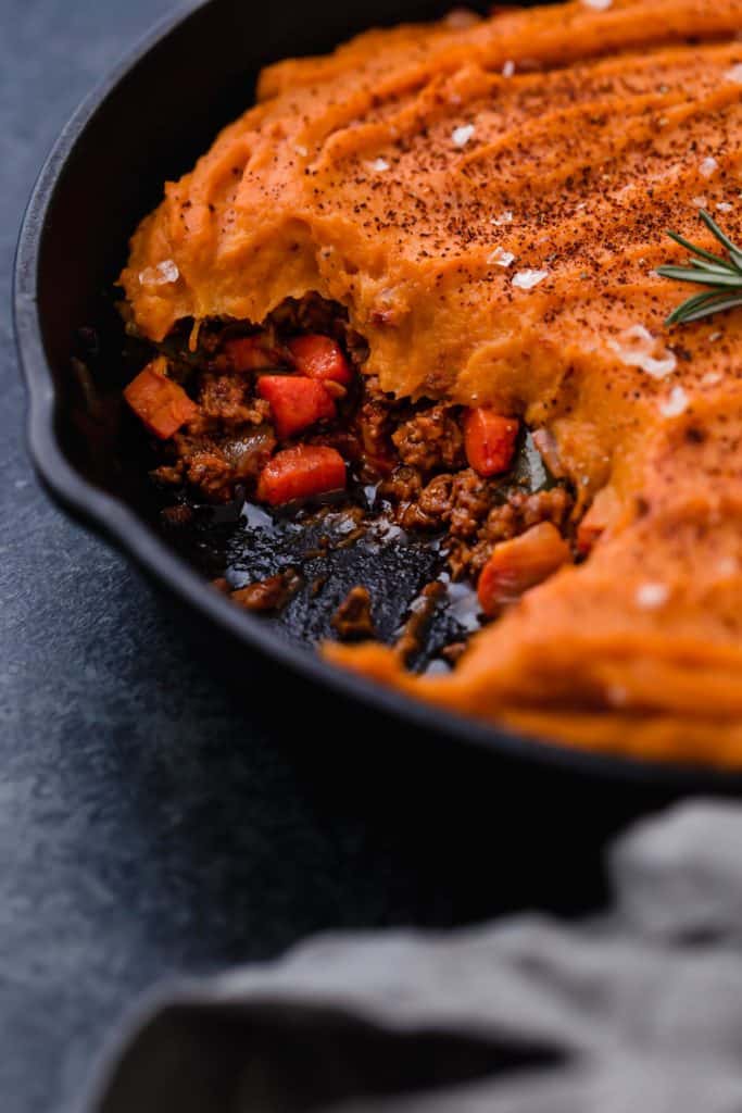 Close up view of Sweet Potato topped Shepherd's Pie in a cast iron skillet.