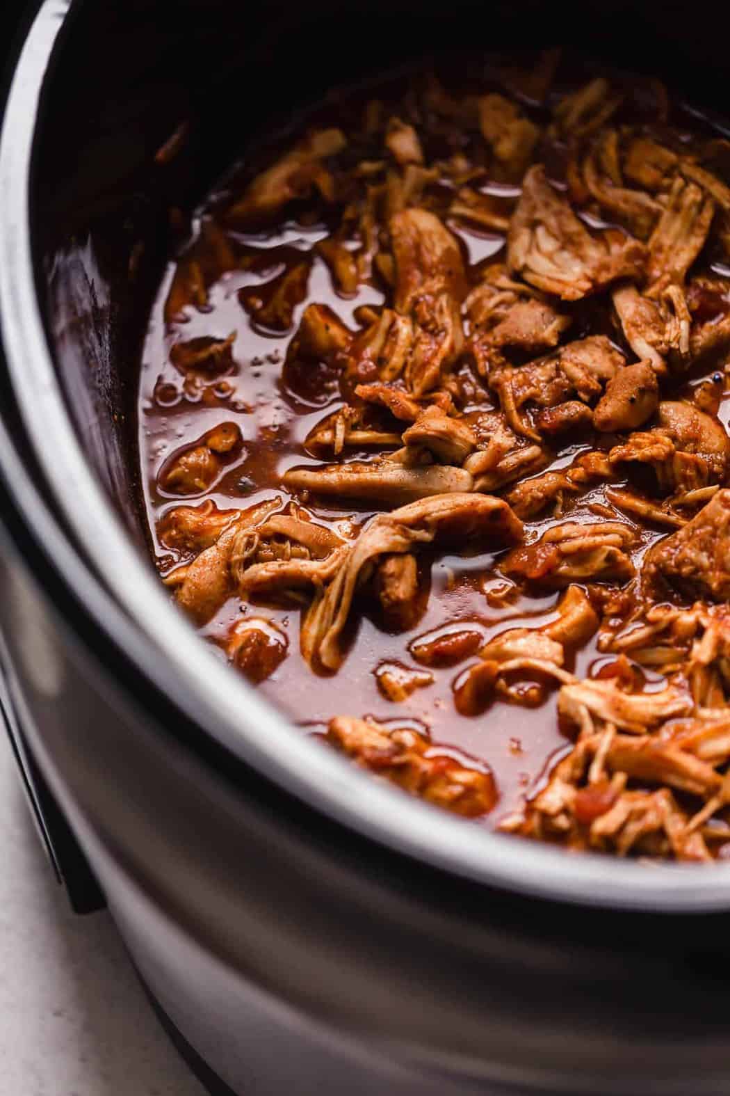 Shredded chicken taco meat in a slow cooker