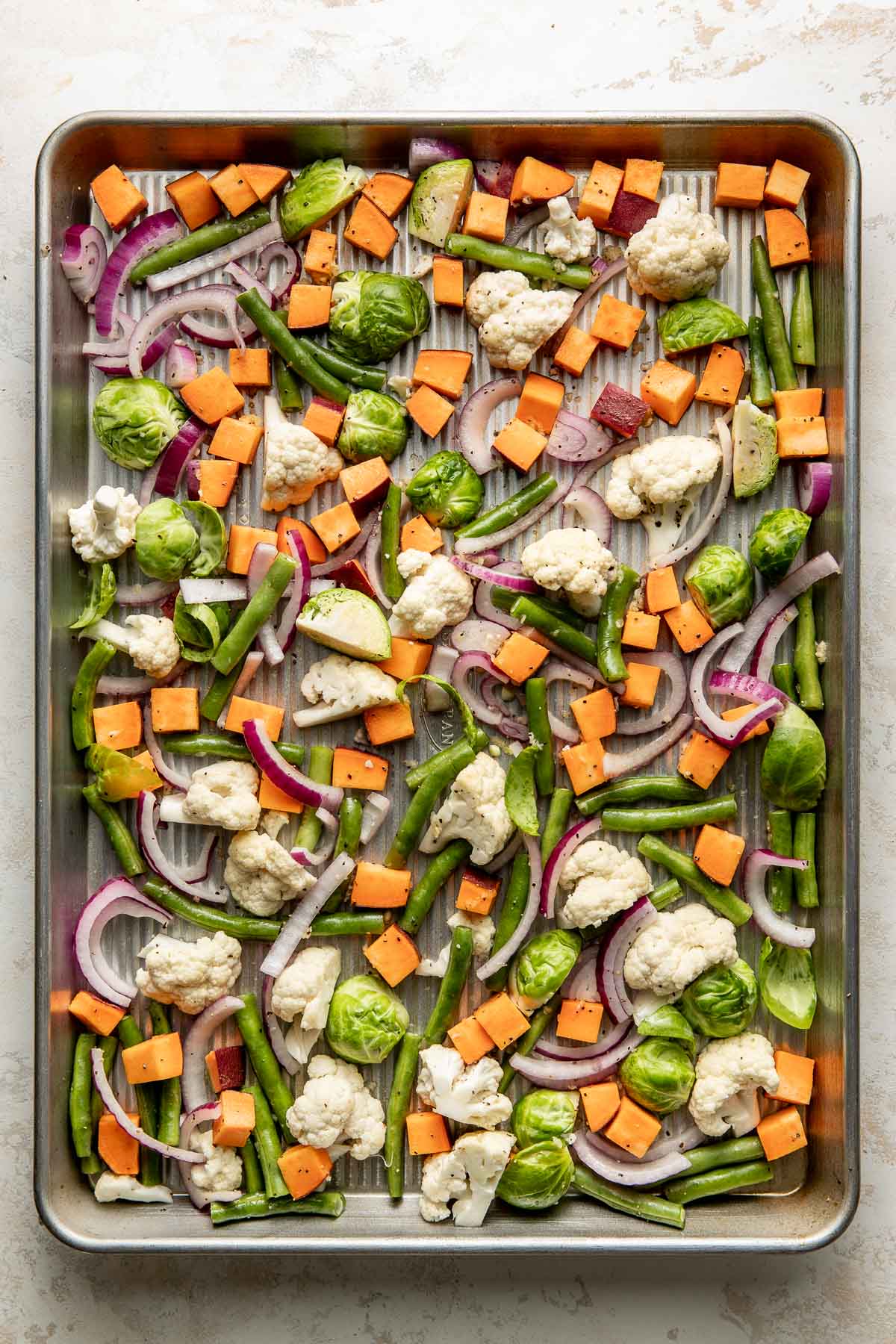 Raw vegetables on a sheet pan.