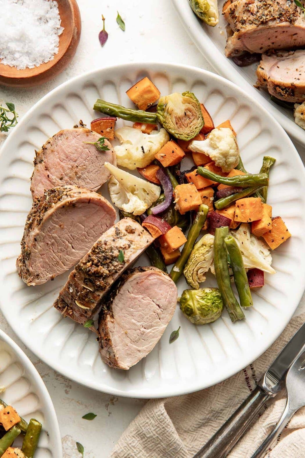 A plate of roasted vegetables and oven roasted pork tenderloin.