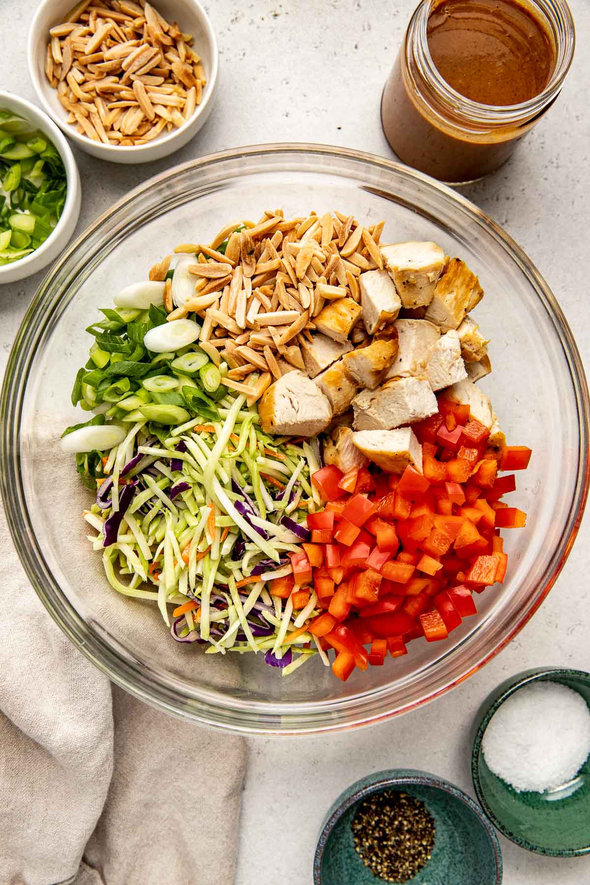 Overhead view of a bowl of Asian inspired chicken salad ingredients ready to be combined. 