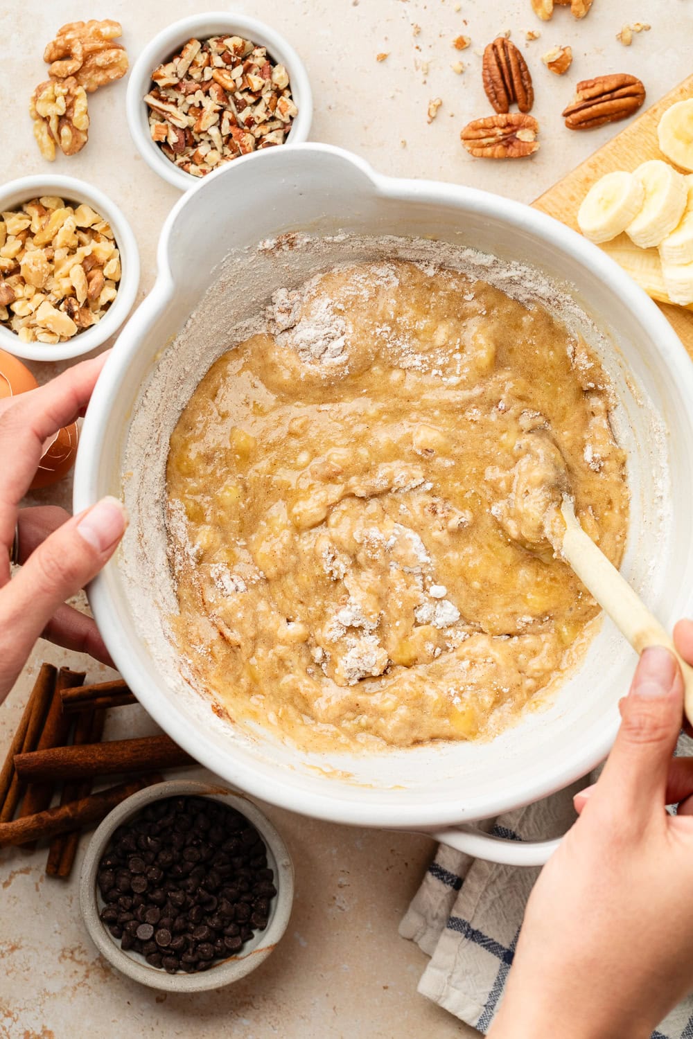 Overhead view of a bowl of mini banana muffin batter ready for stirring. 