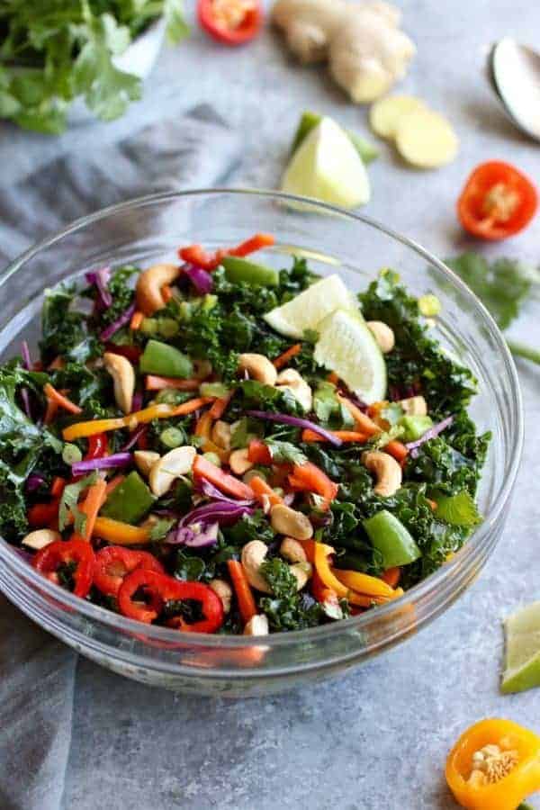Thai Kale Salad with Cashews in a glass bowl