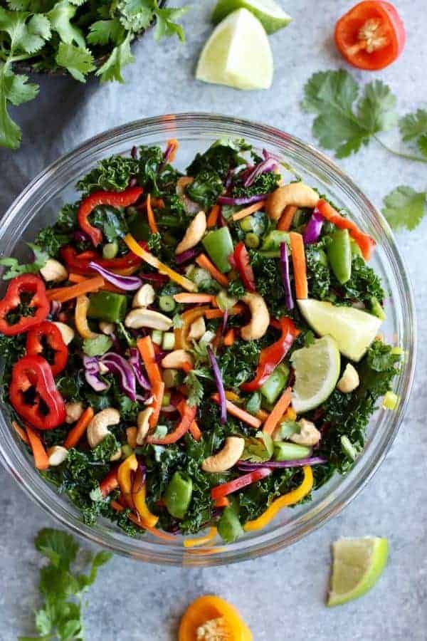 Thai Kale Salad with Cashews in a glass bowl