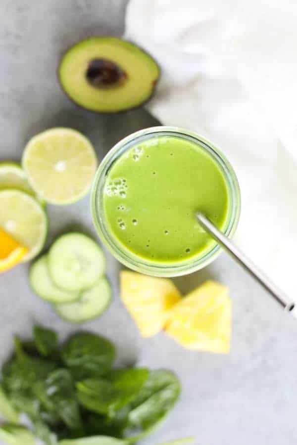 Margarita Green Smoothie with ingredients on a gray counter