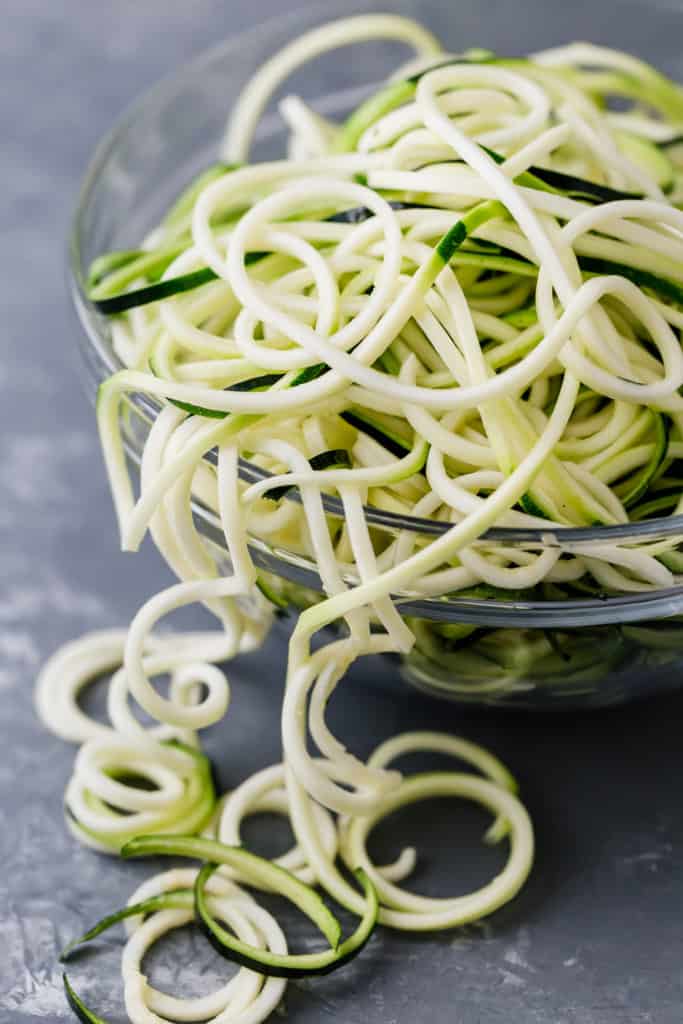 zucchini noodles in a clear glass bowl