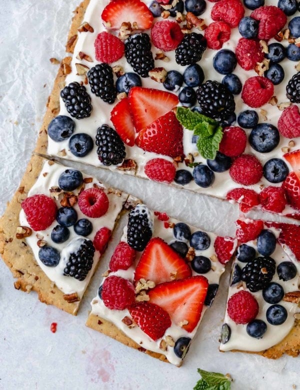 Overhead view berry fruit pizza cut into squares
