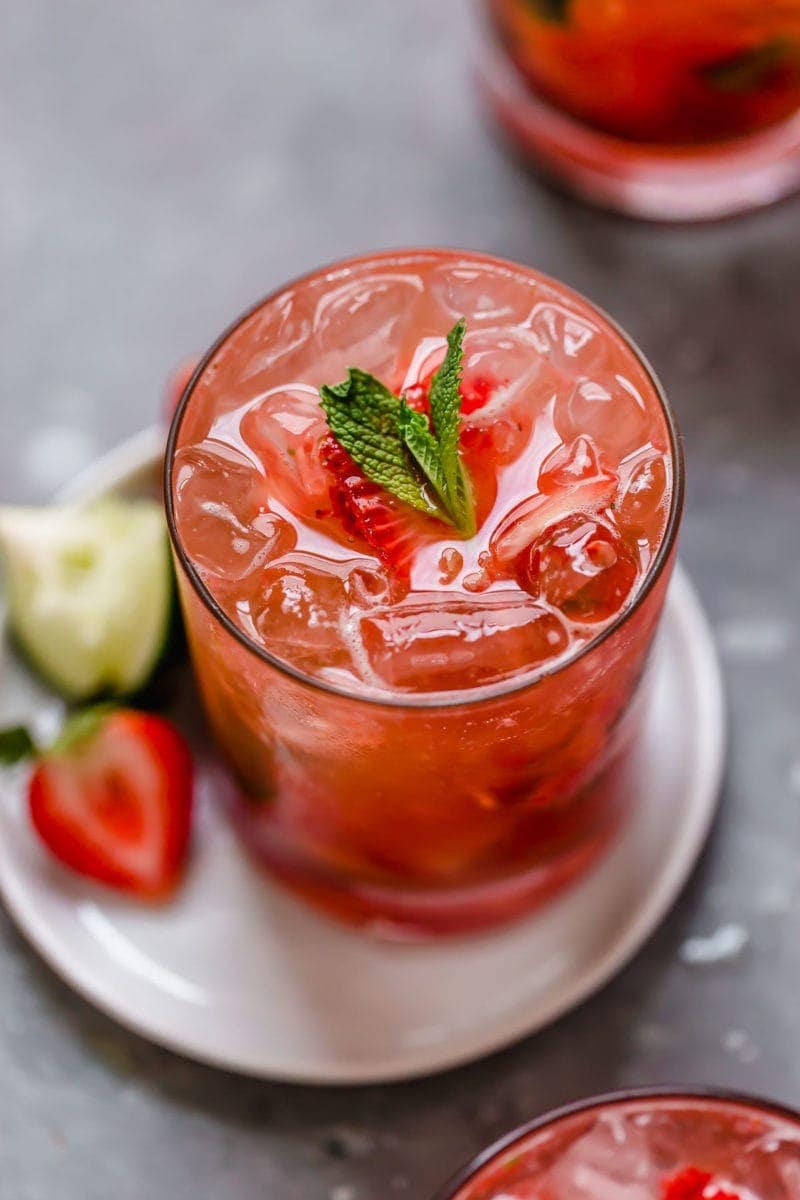 Iced strawberry drink shot from above with strawberry and mint-leaf garnish on top