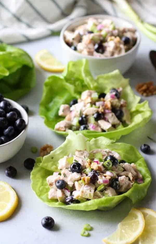 Blueberry Chicken Salad and Rosemary in lettuce bowls on a table