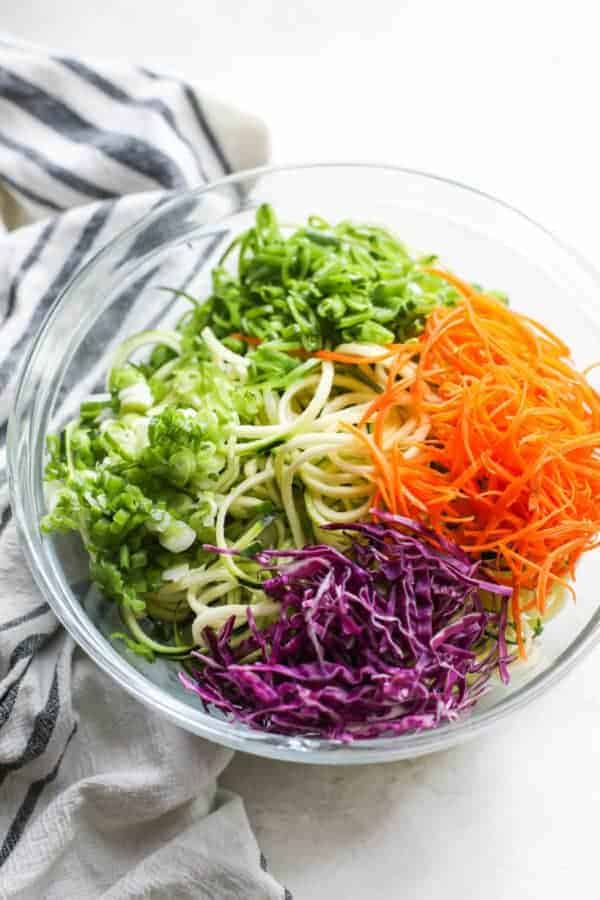 Spicy Asian Zucchini Noodles ingredients in a glass bowl