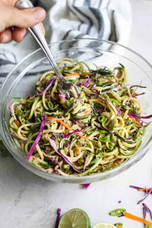 Spicy Asian Zucchini Noodles in a glass bowl with a fork