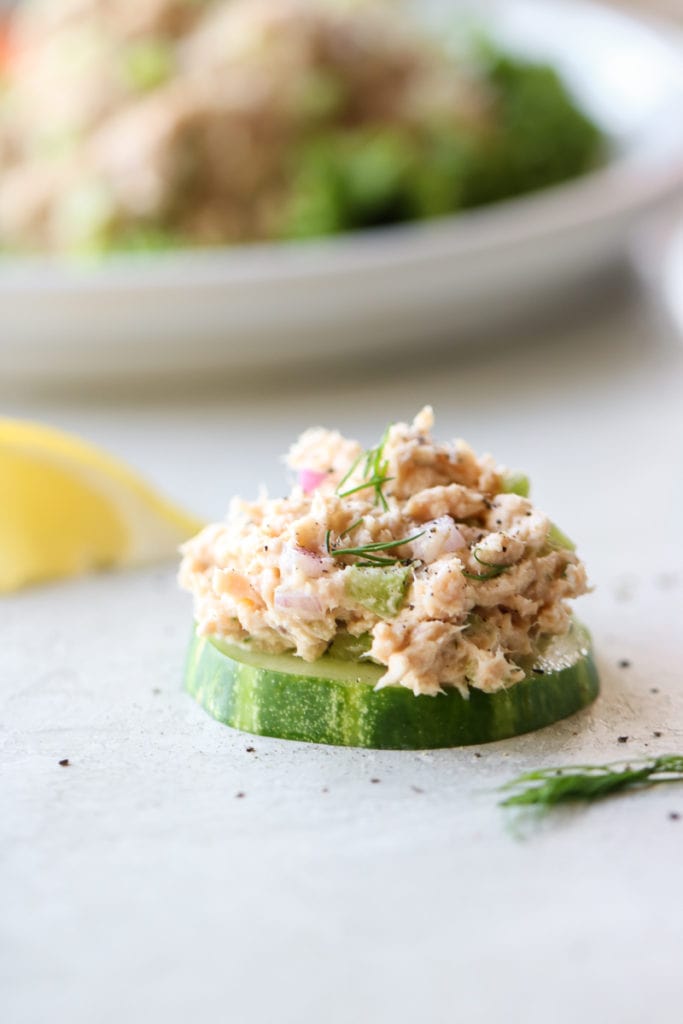 Salmon salad topped on a cucumber slice.
