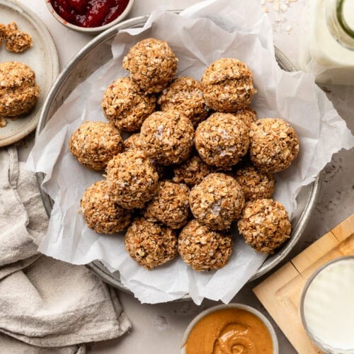 No-Bake PB & J Bites on a plate with parchment paper.