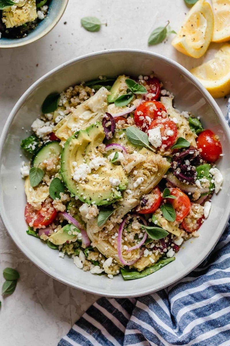 Bowl filled with Greek quinoa salad with avocado and feta cheese