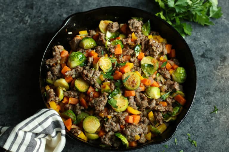 Brussels sprouts sweet potato sausage hash in cast iron skillet