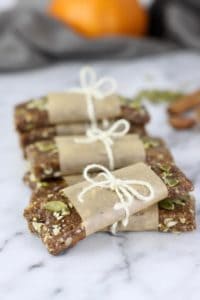 Pumpkin Spice Protein Bars wrapped in paper and tied with a string bow on a counter