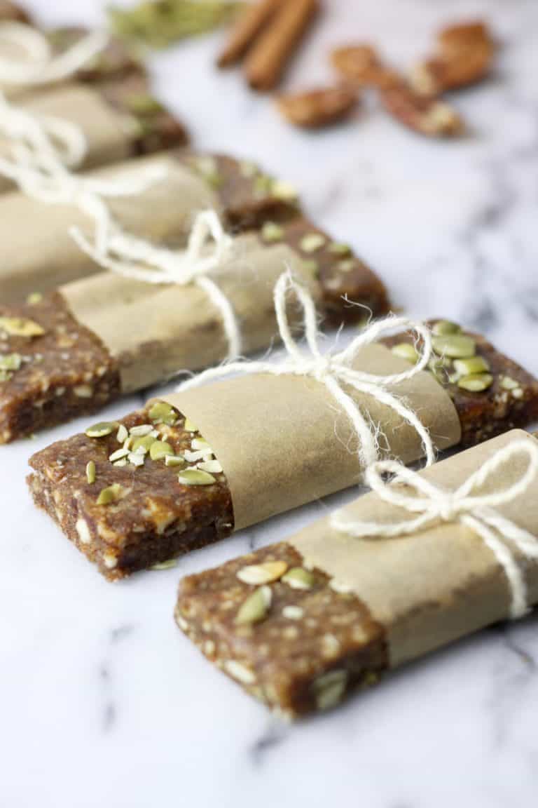 A line of nicely wrapped pumpkin spice protein bars naturally sweetened with dates and pumpkin puree. 