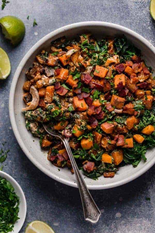 Overhead photo of Warm Chipotle Lime Sweet Potato Salad in a grey bowl with a spoon in it.
