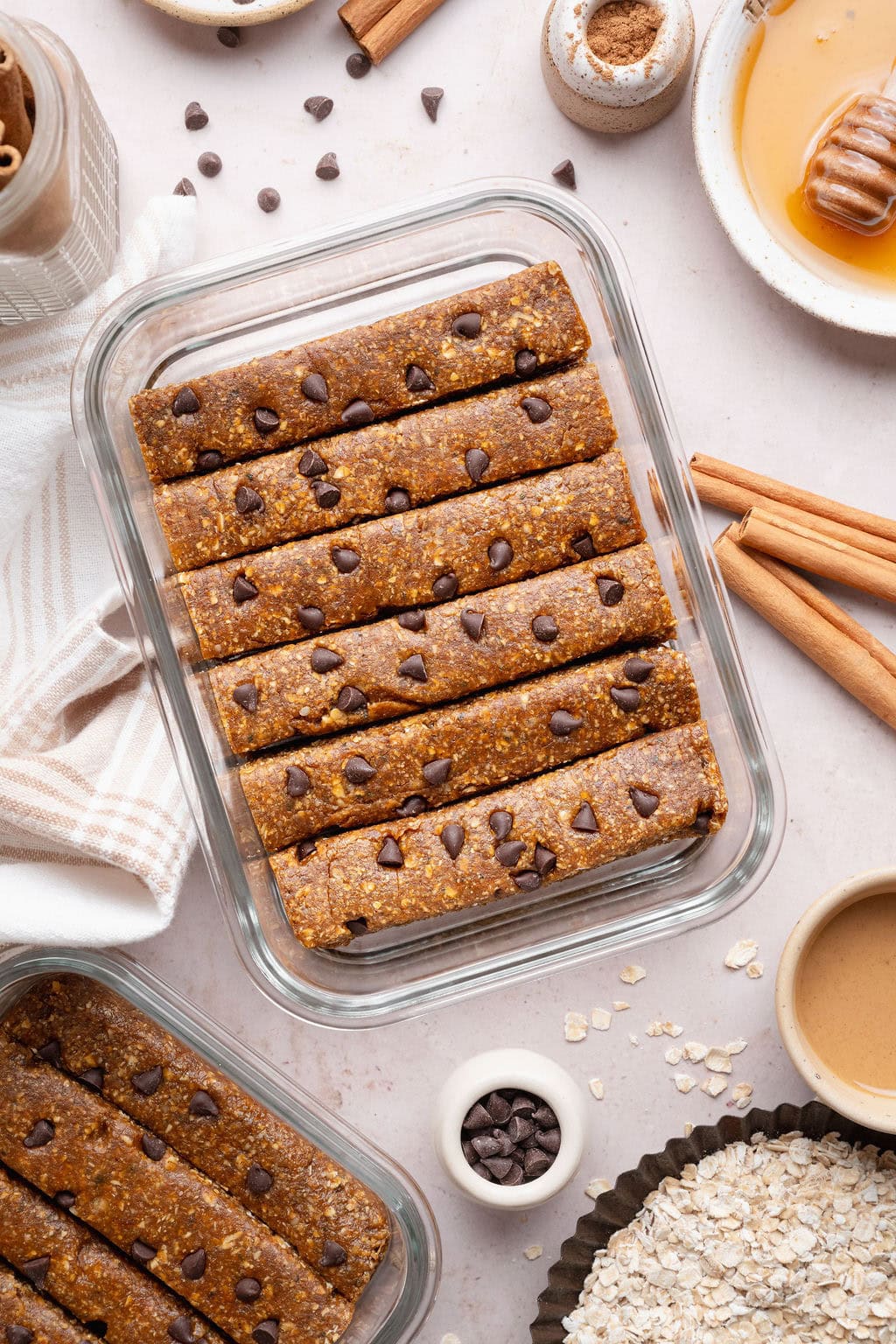 Six chocolate chip pumpkin protein bars in a glass container.