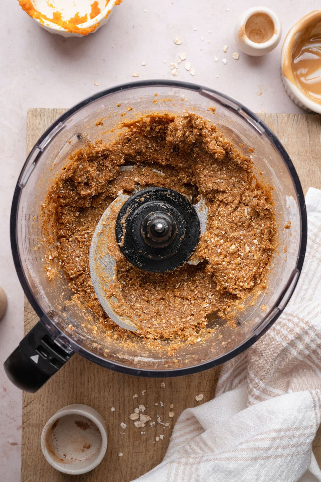 Pumpkin protein bar batter in the bowl of a food processor.