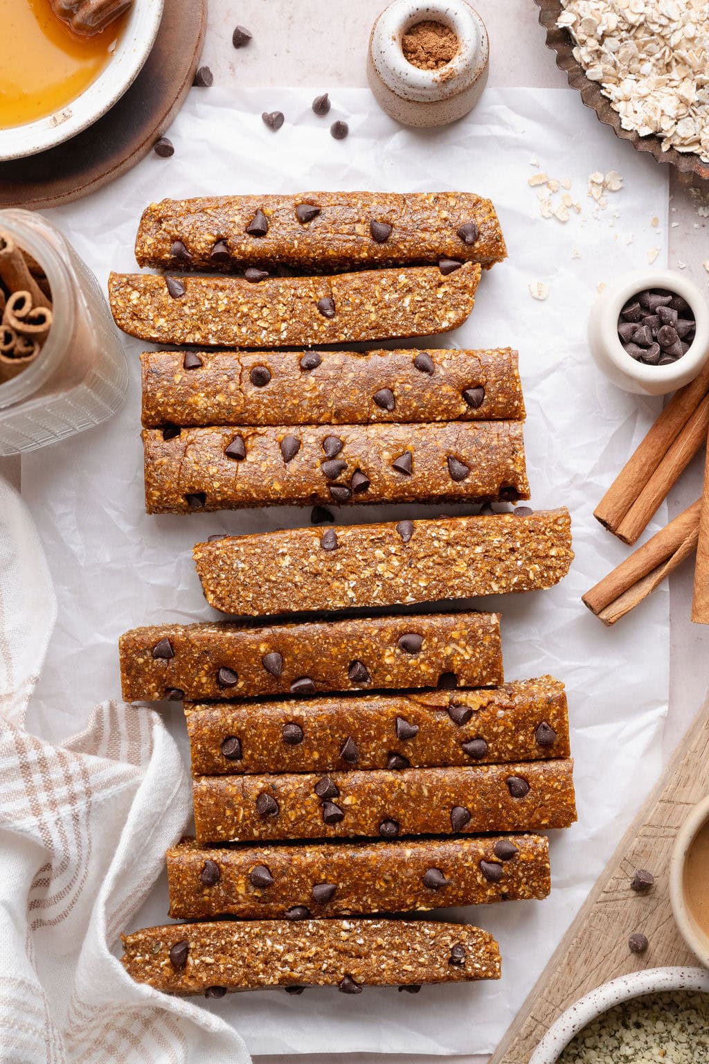 Pumpkin protein bars with chocolate chips on a sheet of parchment paper.