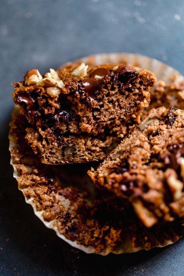 Close up of a Grain-Free Sweet Potato Banana Nut Muffin that has been sliced in half revealing the delicate crumb. 