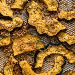 Roasted acorn squash slices with fresh herbs and Parmesan cheese.