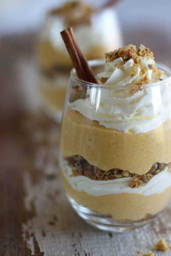 close up of one No-Bake Pumpkin Cheesecake Parfait with another in the background