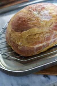 Cooked Ham on a wire cooling rack