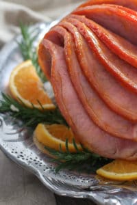 close up view of Orange Glazed Ham on a silver platter