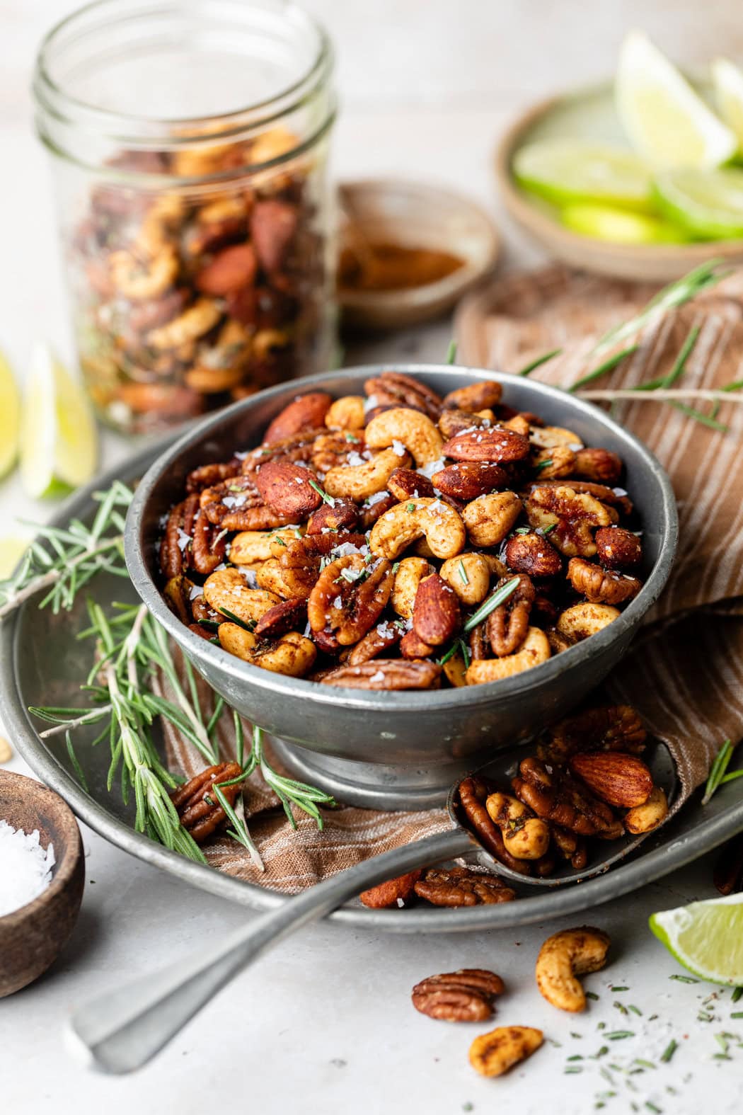 Close up view of a bowl of Chili Rosemary Roasted Nuts ready for serving. 