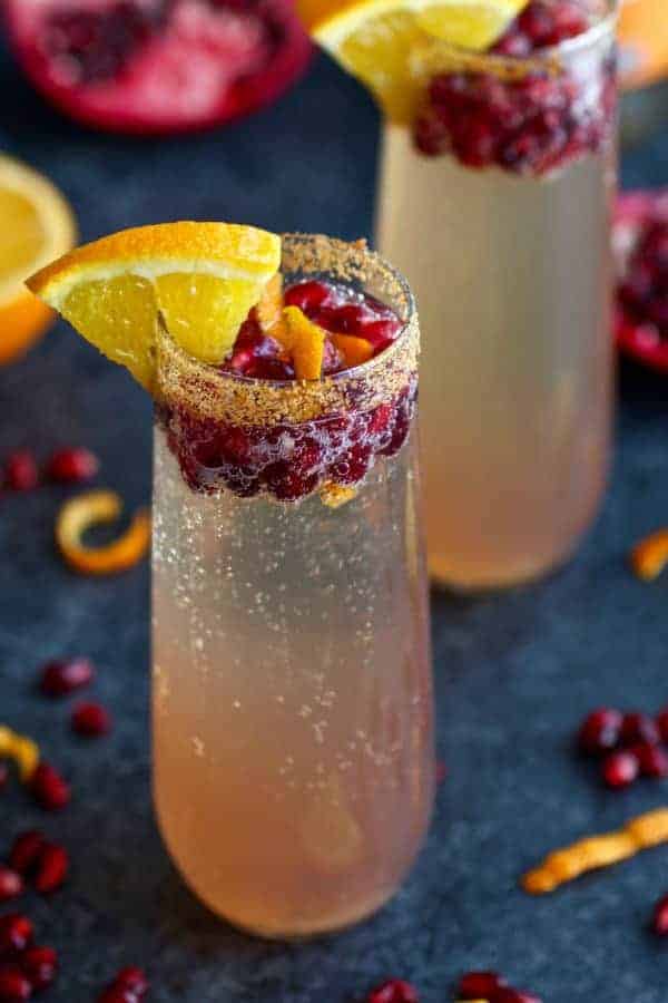 This Pomegranate Kombucha Mimosa recipe is a twist off of the traditional champagne and OJ combo with the addition of flavor bursting pomegranate seeds and probiotic rich LIVE Kombucha. | Paleo mimosa recipe | Vegan mimosa recipe | dairy-free mimosa recipe | healthy mimosa recipe | paleo drink recipes | vegan drink recipes | dairy-free drink recipes || The Real Food Dietitians #mimosas #paleodrinks #vegandrinks #healthymimosa