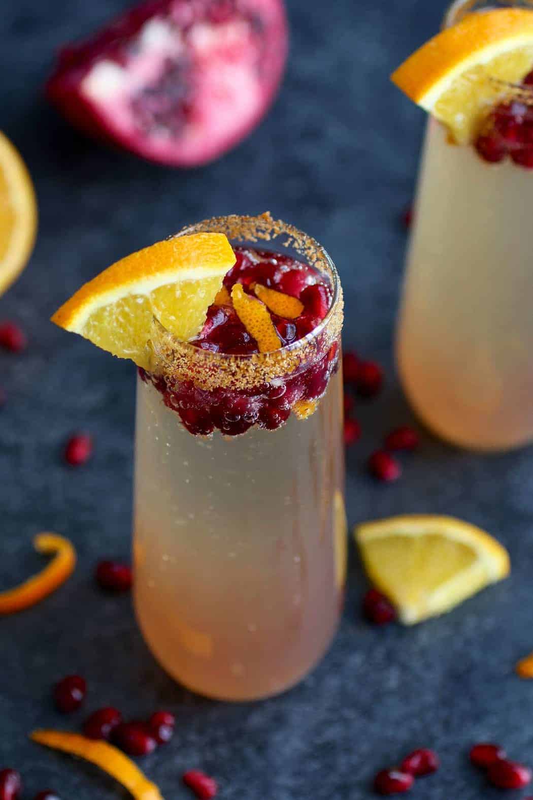 This Pomegranate Kombucha Mimosa recipe is a twist off of the traditional champagne and OJ combo with the addition of flavor bursting pomegranate seeds and probiotic rich LIVE Kombucha. | Paleo mimosa recipe | Vegan mimosa recipe | dairy-free mimosa recipe | healthy mimosa recipe | paleo drink recipes | vegan drink recipes | dairy-free drink recipes || The Real Food Dietitians #mimosas #paleodrinks #vegandrinks #healthymimosa