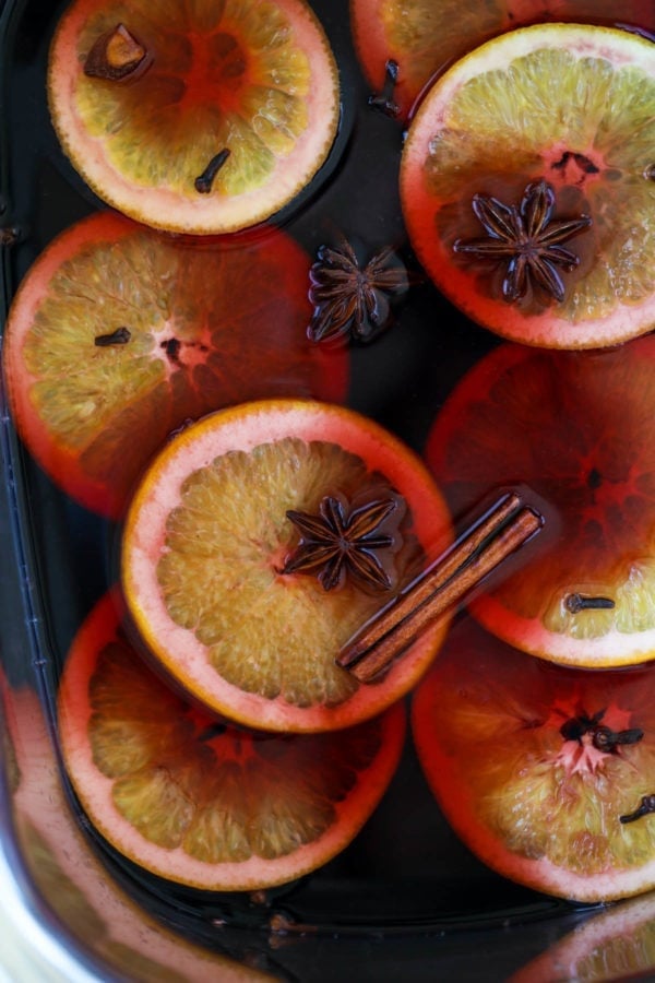 mulled wine in a crockpot with orange, cinnamon and star anise