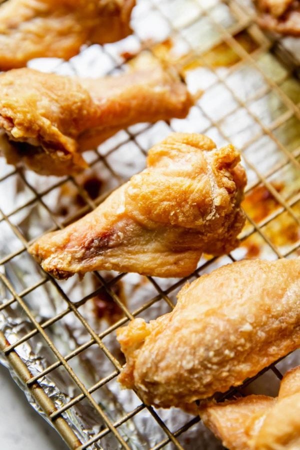 Perfectly brown and crispy baked wings on a baking rack over a baking sheet