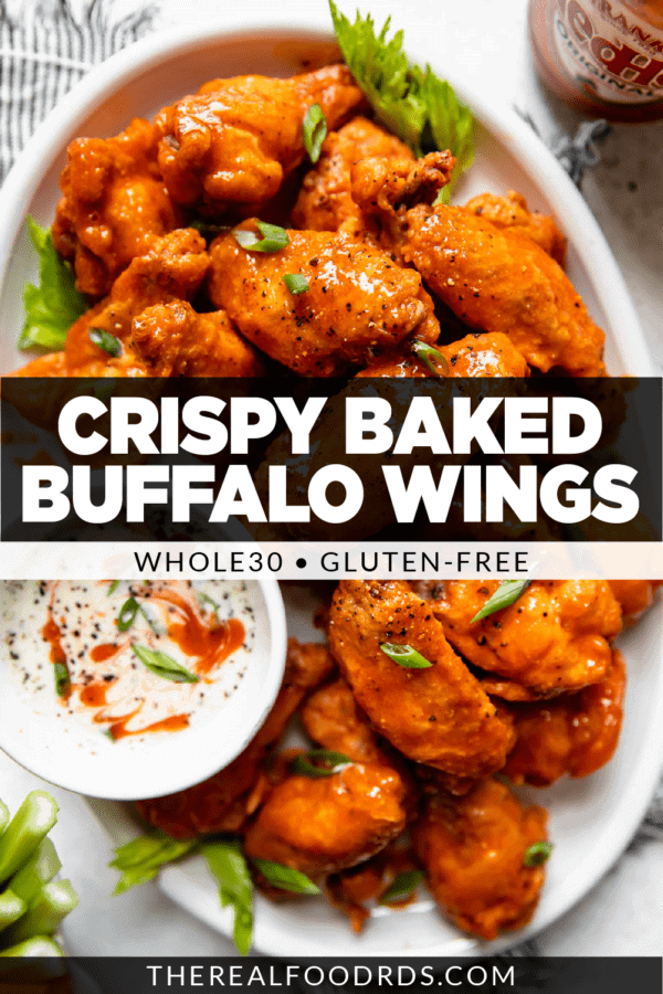 Crispy baked Buffalo wings piled high on a white platter coated in homemade Buffalo sauce