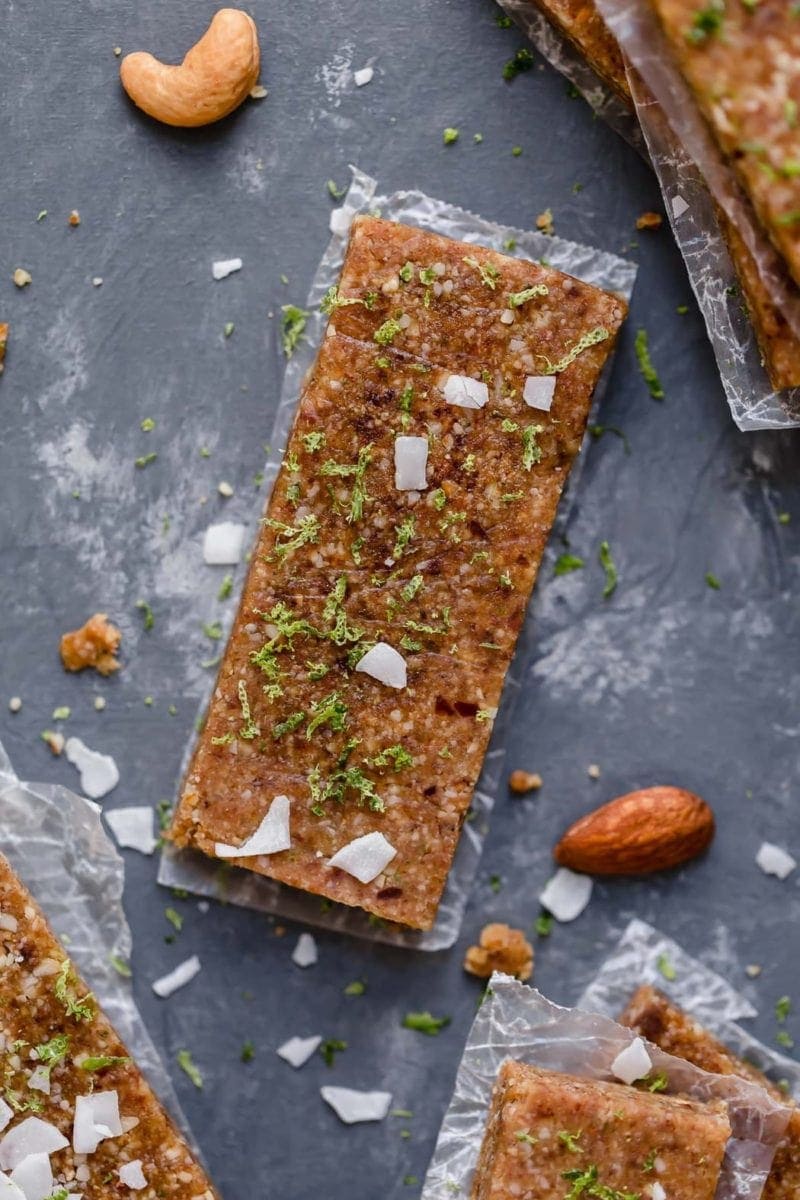 Overhead view key lime energy bar on piece of parchment paper topped with lime zest.