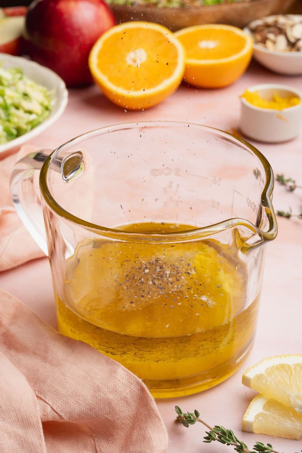 Citrus vinaigrette ingredients in a glass measuring cup.