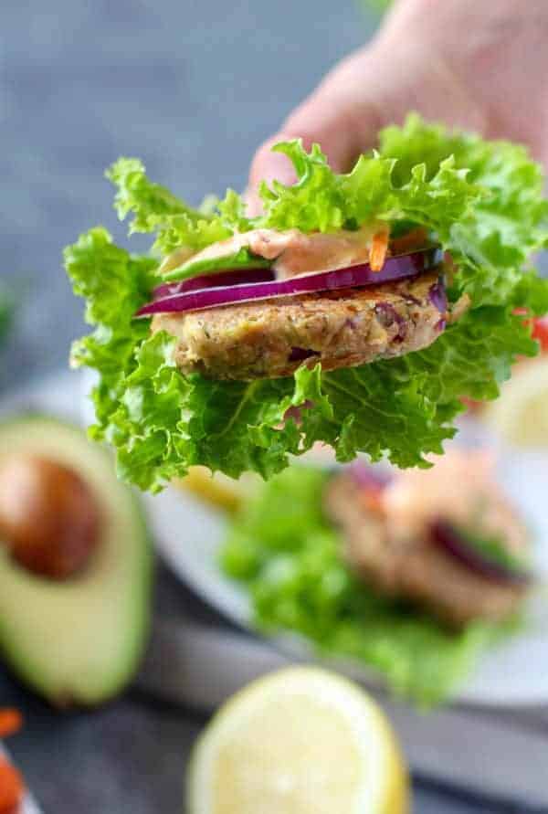 Easy Tuna Cakes with Roasted Red Pepper Mayo in a person's hand