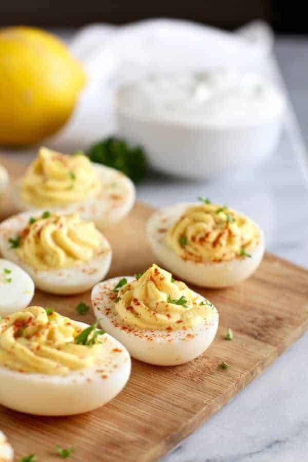 Greek Yogurt Deviled Eggs on brown cutting board