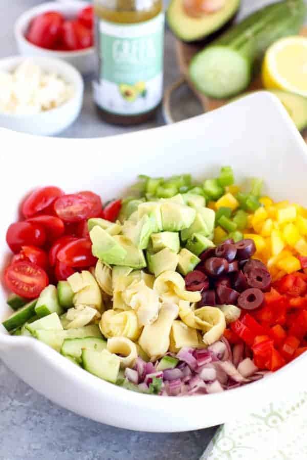 Greek Kale Salad with Avocado ingredients in a white bowl